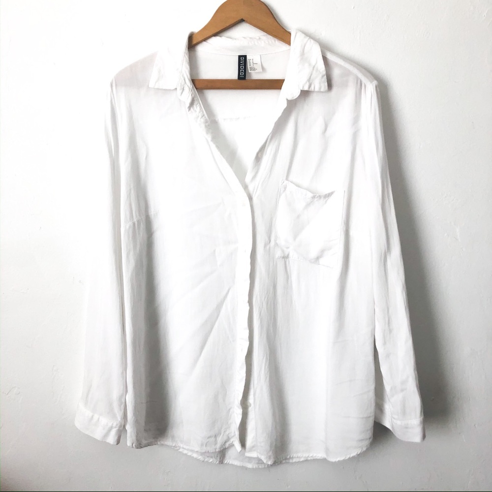 A long-sleeved white button up blouse made by H&M.